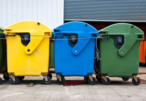 Removal crew standing beside sorted waste and recycling bins